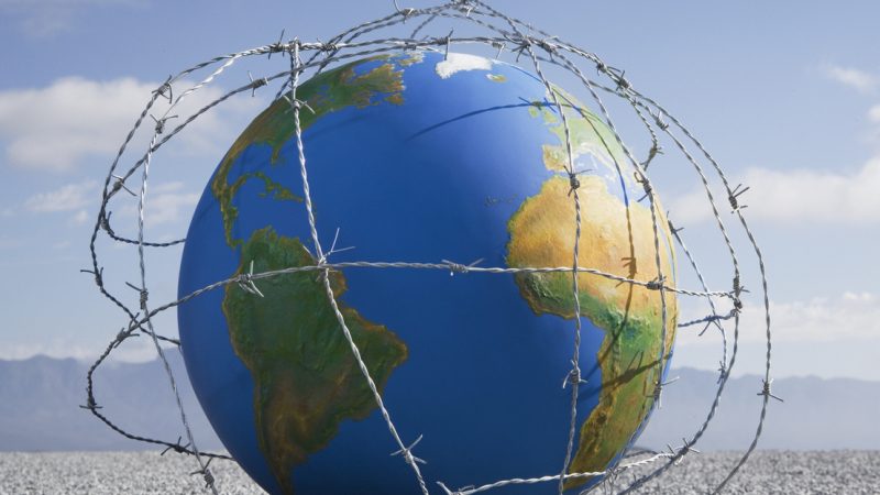A globe entangled in barbed wire